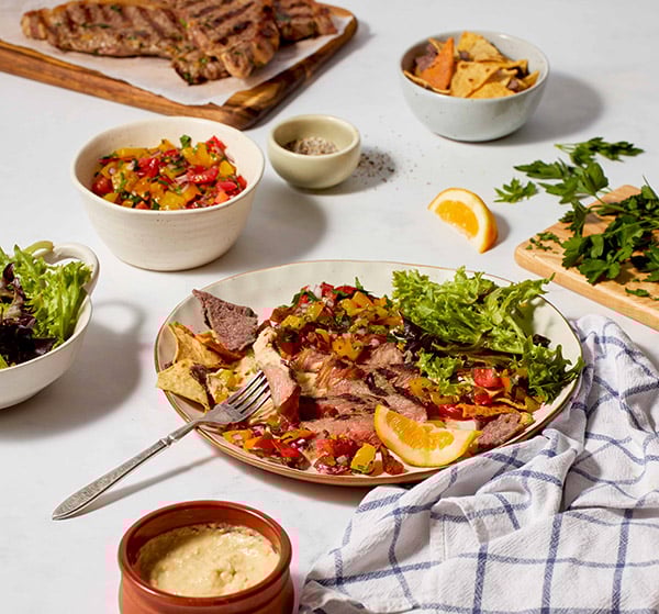 BBQ steak with hummus and tomato salsa