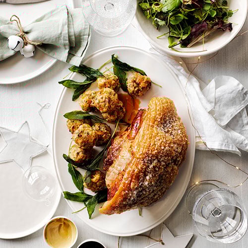 Roast pork leg with sage and apricot stuffing balls