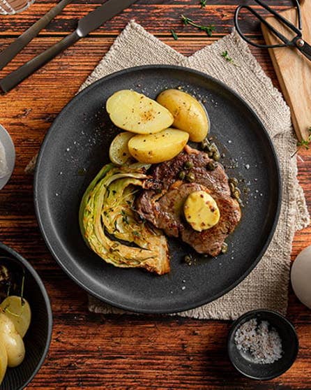 Grilled steak with capers and cabbage