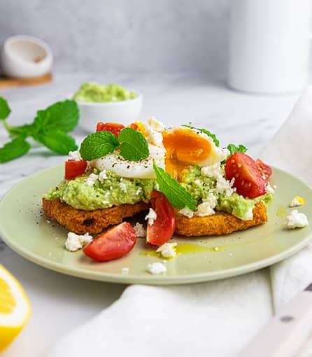 Smashed avocado and poached eggs on hash browns