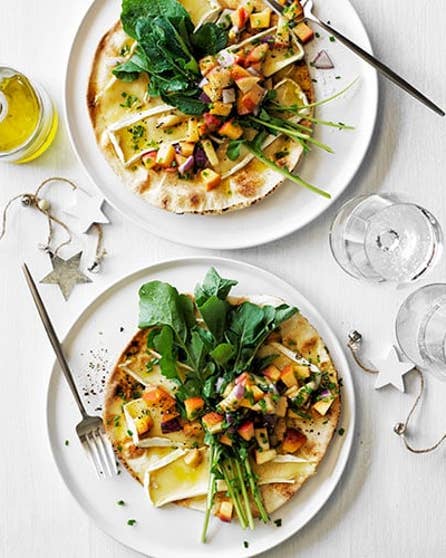 Baked flatbreads with brie, peaches and rocket